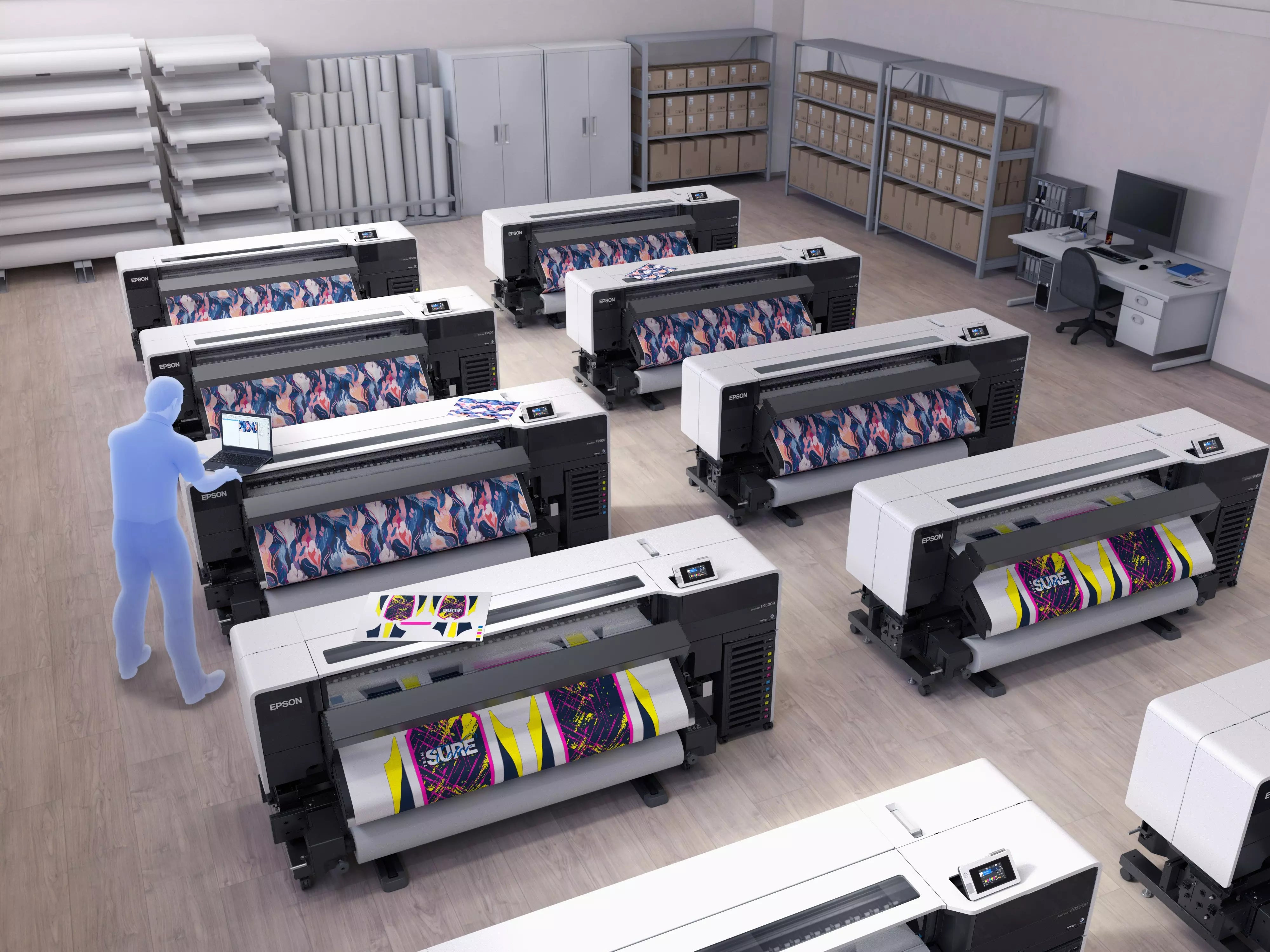 A workspace featuring multiple Epson SC-F9500H dye-sublimation printers in action, showcasing vibrant printed designs.